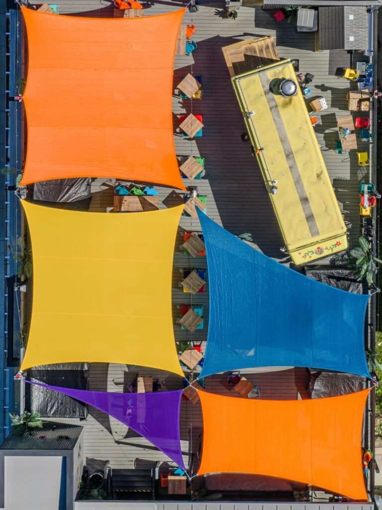 birds eye view of custom shade sails on rooftop patio 
